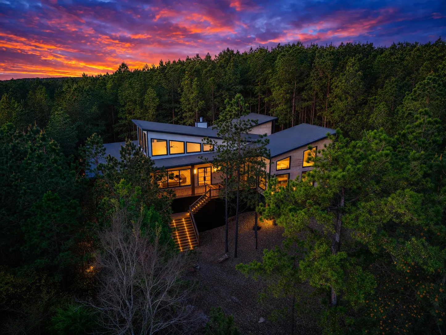 The Arcadia designer cabin interior with soaring ceilings, floor-to-ceiling glass, and gold fixtures in Hochatown Broken Bow