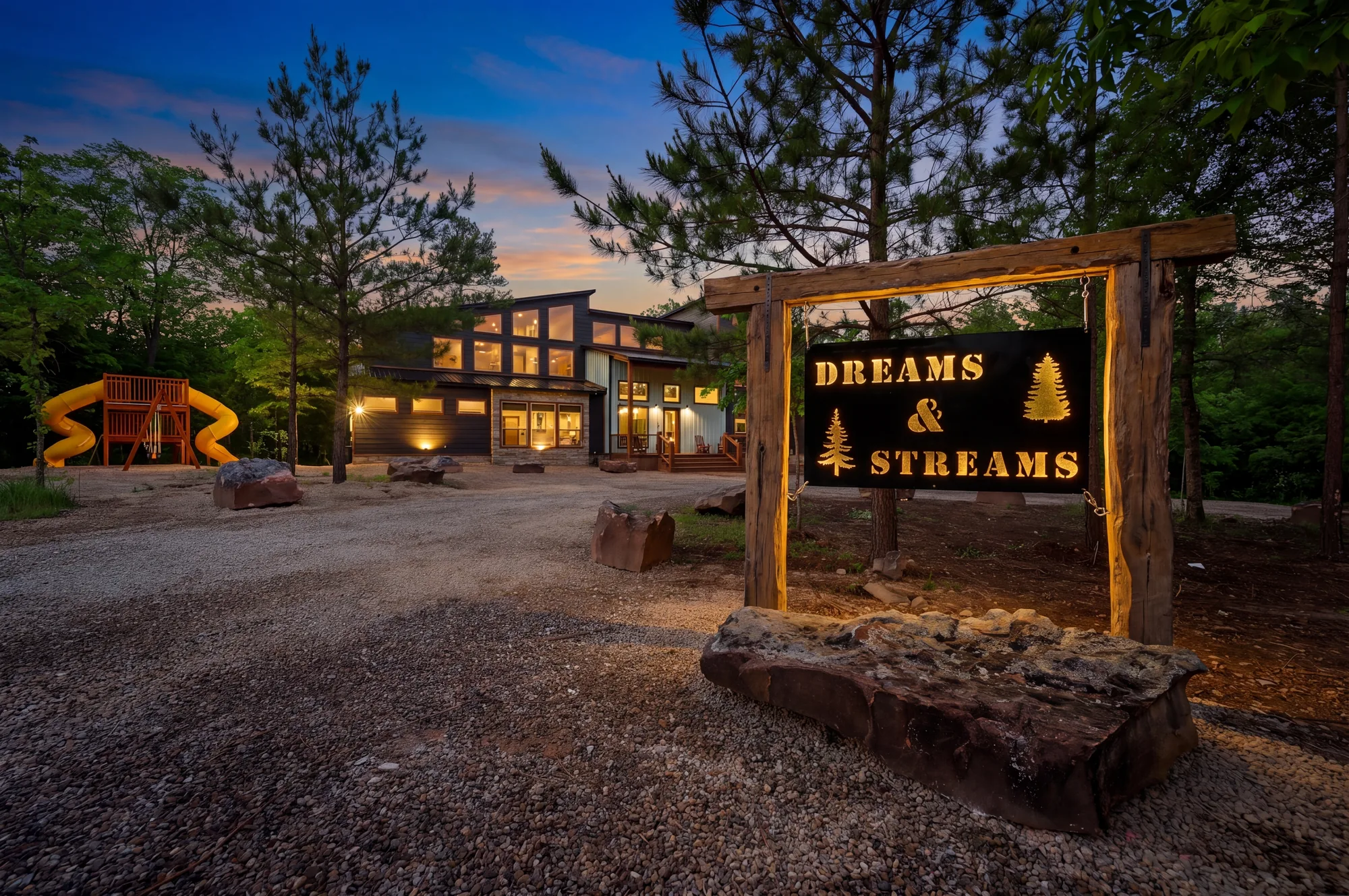 Dreams and Streams luxury creekside cabin in Broken Bow — sleeps 36 guests with private creek, two hot tubs, and playground