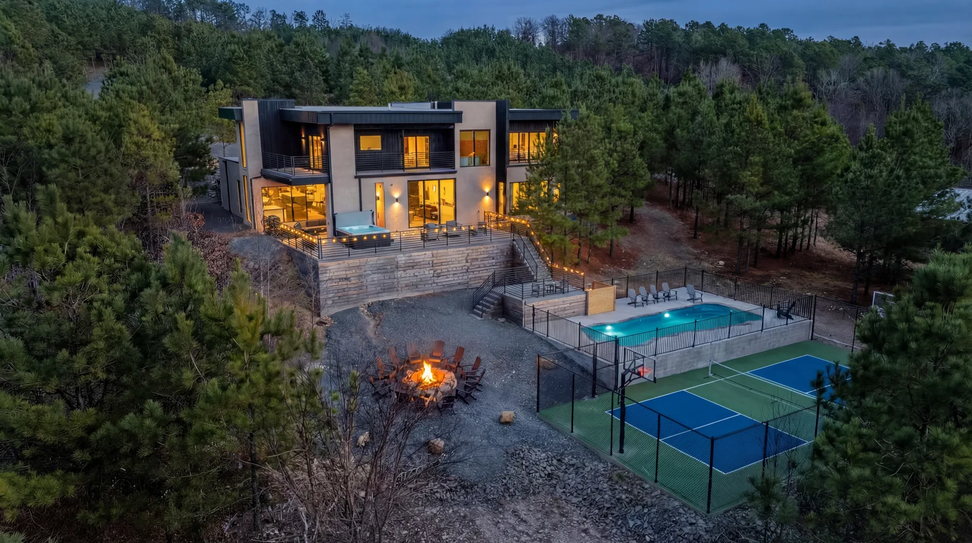 The Jade luxury cabin in Broken Bow — aerial view showing private pool, hot tub, sport court, and forest setting